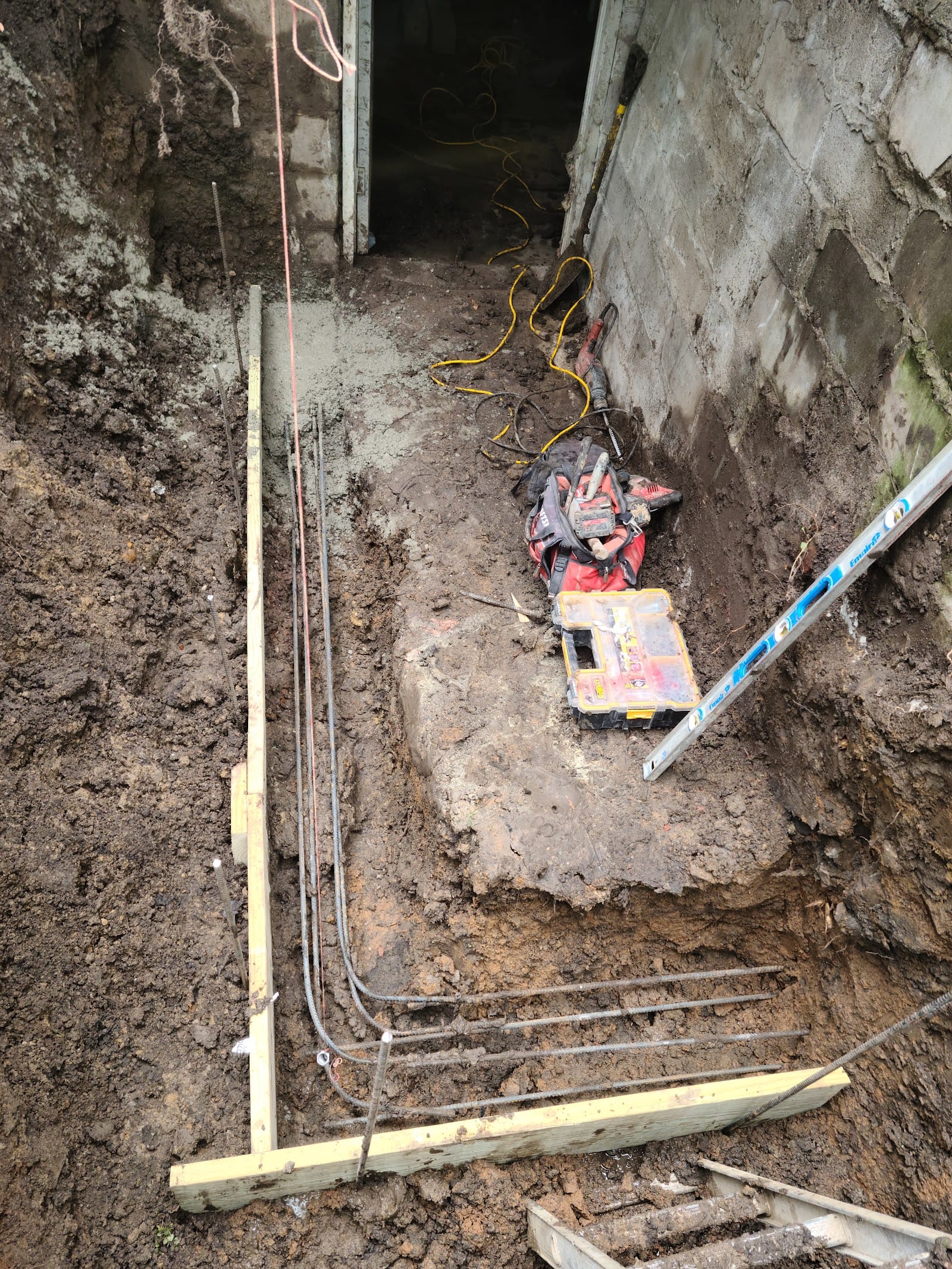 Exterior foundation excavation and drainage work in progress