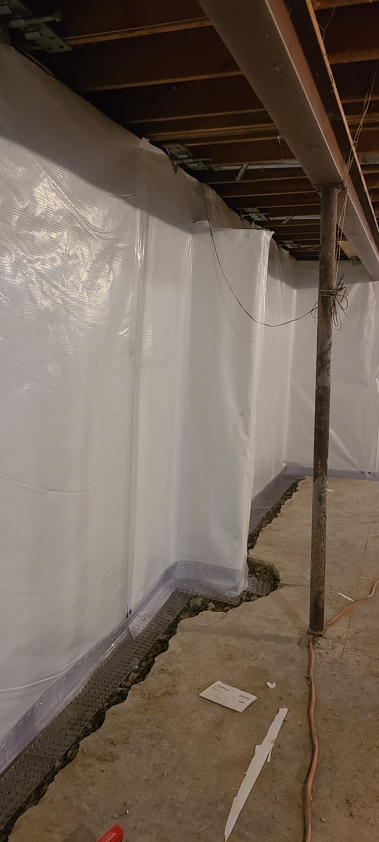 Interior basement wall sealed with a waterproofing membrane