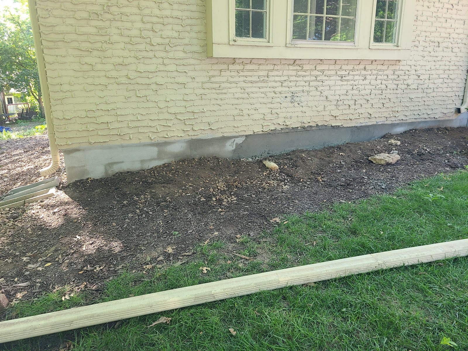Foundation and grading repair along a brick home's exterior